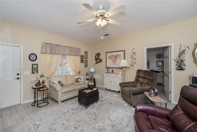 living room featuring ceiling fan and wood-type flooring