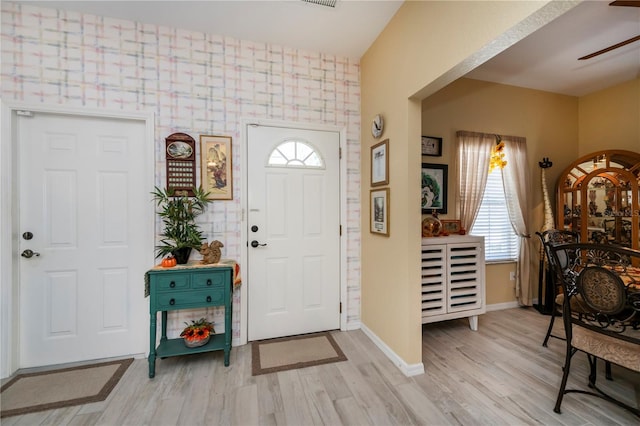 foyer entrance with light hardwood / wood-style floors