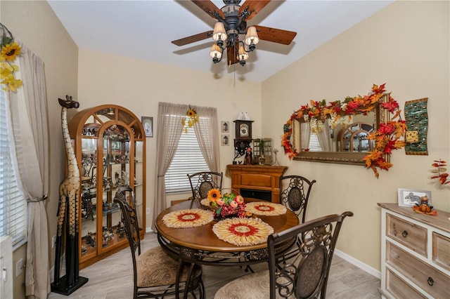 dining room with light wood-type flooring and ceiling fan