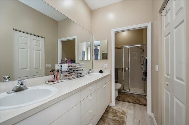 bathroom featuring vanity, hardwood / wood-style floors, toilet, and walk in shower