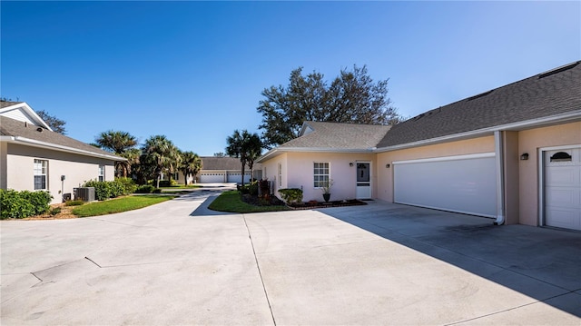 exterior space featuring central AC and a garage