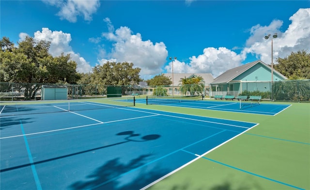 view of tennis court featuring basketball court