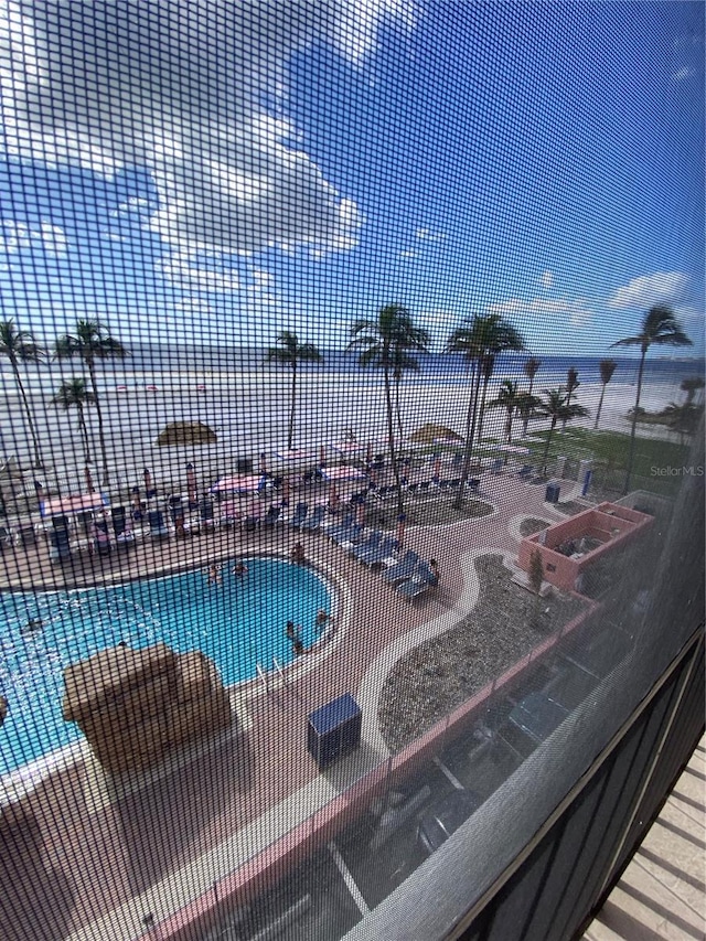 view of swimming pool featuring a water view