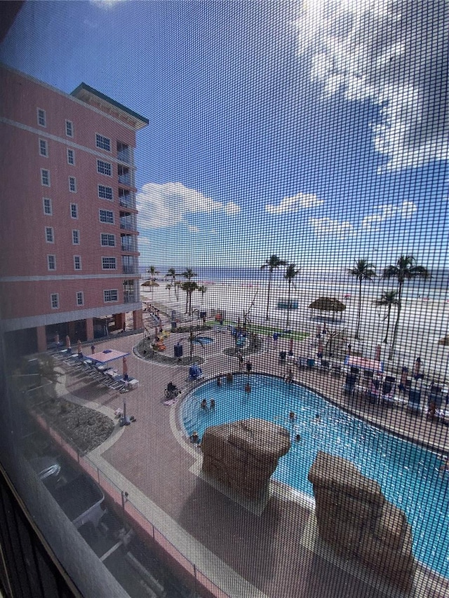 view of pool with a water view and a jacuzzi