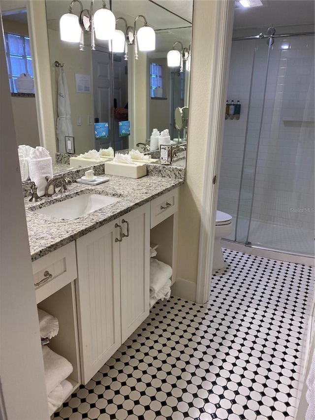 bathroom featuring vanity, toilet, and walk in shower