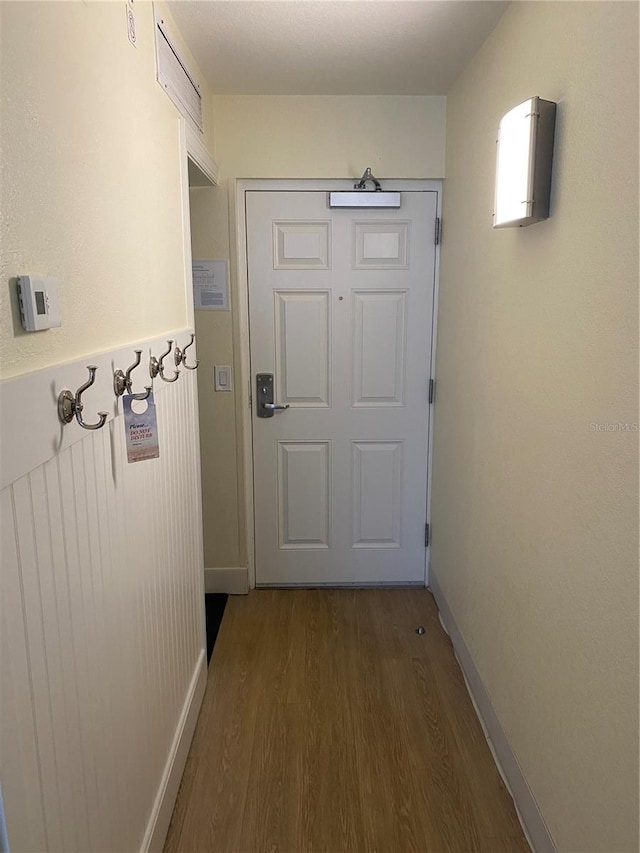 doorway with dark hardwood / wood-style floors