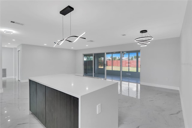 kitchen with a spacious island, an inviting chandelier, and pendant lighting