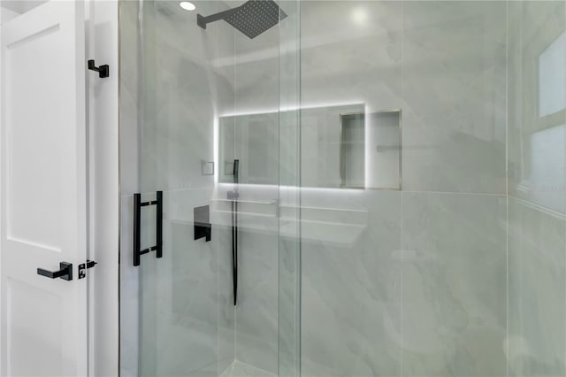 bathroom with a shower with shower door