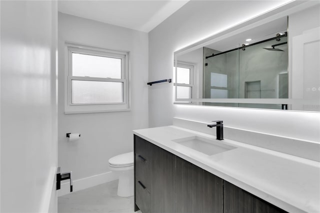 bathroom with a healthy amount of sunlight, vanity, toilet, and walk in shower