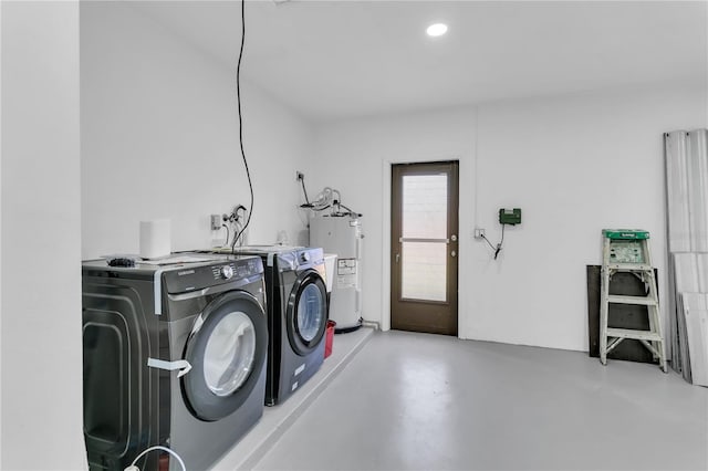 laundry room featuring water heater and washer and dryer