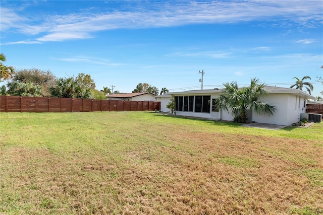 view of yard featuring central AC and a sunroom