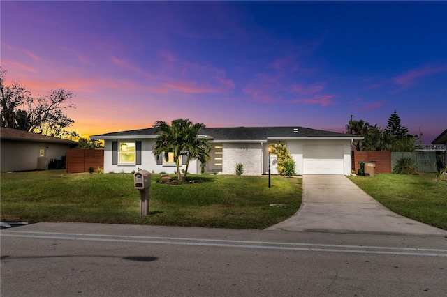 single story home with a lawn and a garage