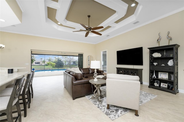 living room with ceiling fan, crown molding, and a tray ceiling