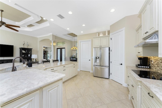 kitchen with ornamental molding, pendant lighting, backsplash, stainless steel fridge with ice dispenser, and black electric stovetop