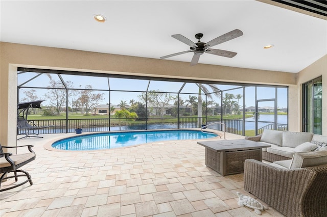 view of pool with an outdoor living space, a patio area, and glass enclosure