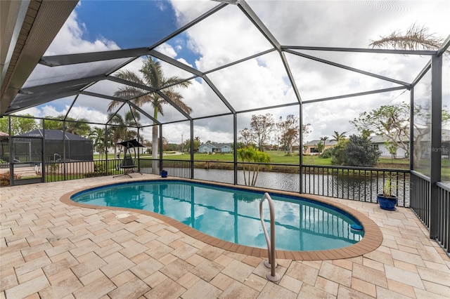 view of pool featuring a water view, glass enclosure, and a patio