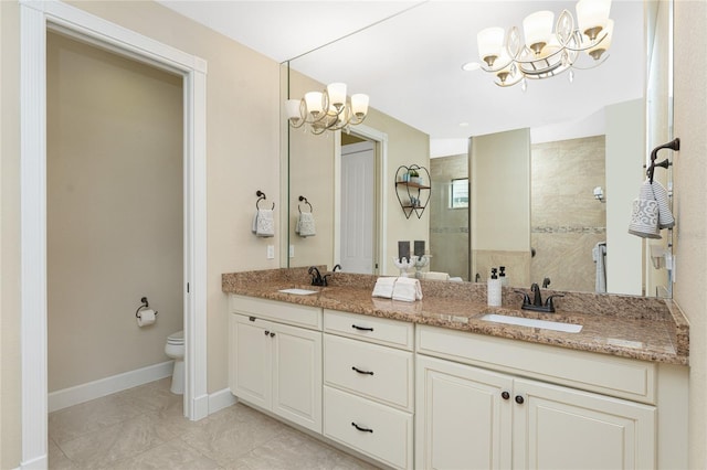 bathroom with vanity, tiled shower, a notable chandelier, tile patterned floors, and toilet