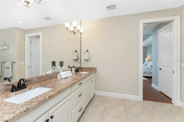 bathroom featuring hardwood / wood-style flooring, a chandelier, and vanity