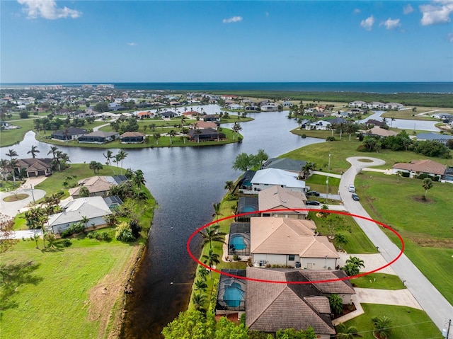 birds eye view of property with a water view