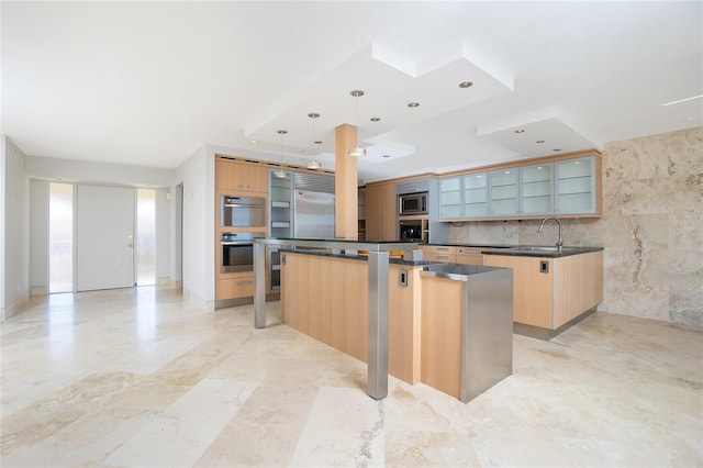 kitchen with a kitchen island, built in appliances, pendant lighting, light brown cabinetry, and tile walls