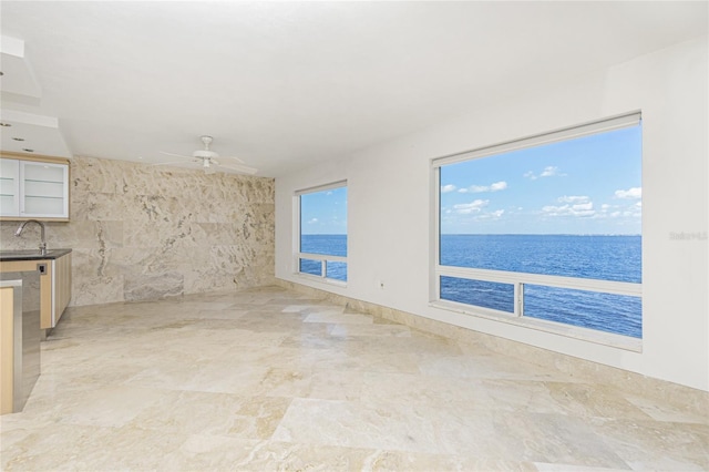 1 Colony Point Dr Unit 16B, Punta Gorda, FL 33950 - unfurnished living room with a ceiling fan, a water view, and a sink