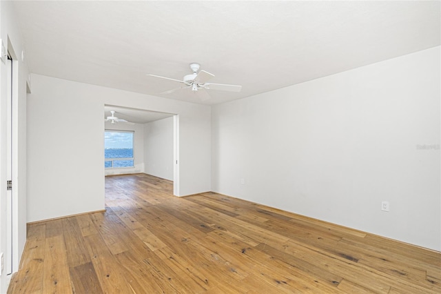 spare room with a ceiling fan and light wood-style flooring