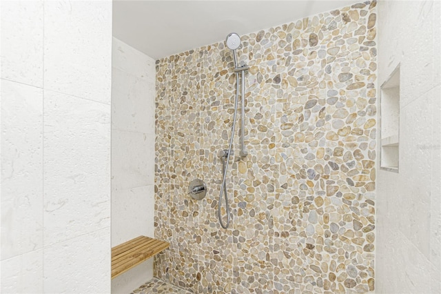 bathroom with tiled shower