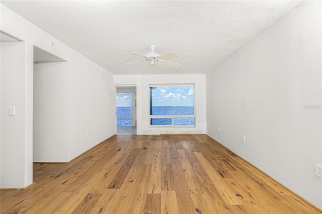 empty room featuring ceiling fan and hardwood / wood-style floors