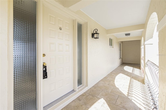 doorway to property with visible vents and stucco siding