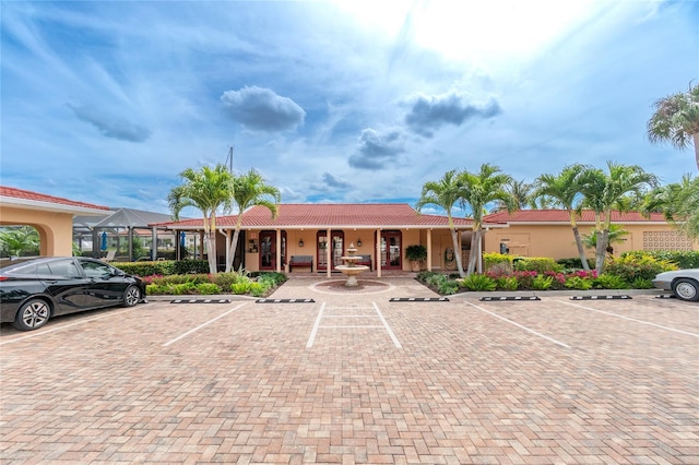 1 Colony Point Dr Unit 16B, Punta Gorda, FL 33950 - view of front of property featuring uncovered parking, a tile roof, and stucco siding