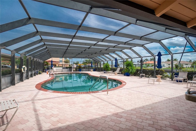 outdoor pool with a patio area and a lanai