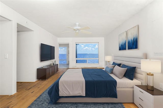 bedroom with ceiling fan and light wood-style floors