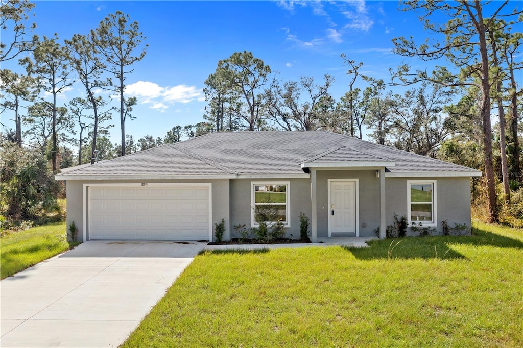 single story home with a front yard and a garage