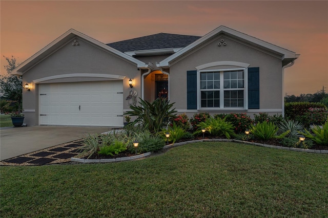 single story home featuring a yard and a garage