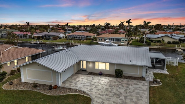 aerial view at dusk featuring a residential view