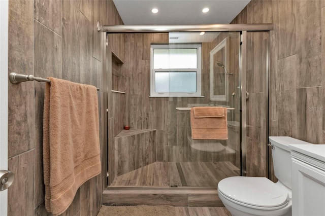 bathroom featuring vanity, toilet, recessed lighting, and a stall shower