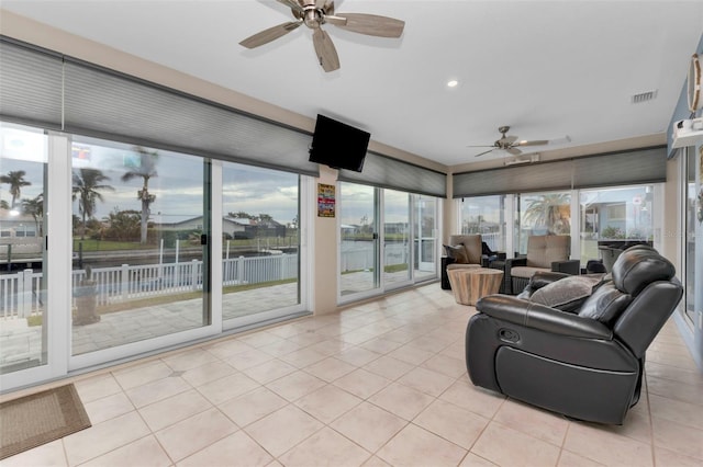sunroom / solarium featuring tile patterned flooring, recessed lighting, and visible vents