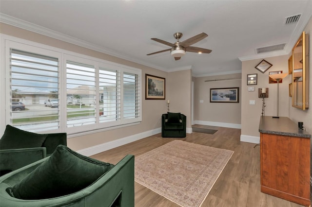 interior space featuring ceiling fan, crown molding, and light hardwood / wood-style flooring