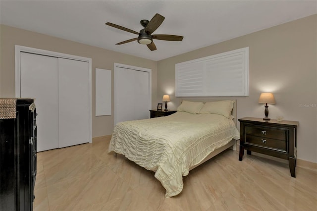 bedroom with multiple closets and ceiling fan