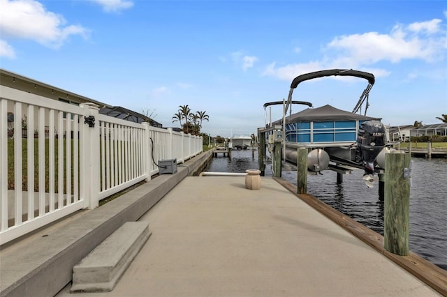 view of dock with boat lift and a water view