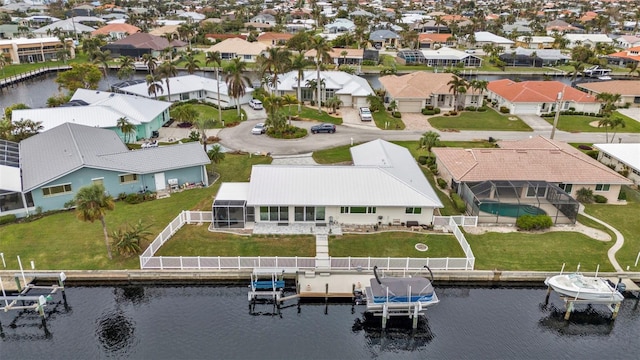 drone / aerial view featuring a residential view and a water view
