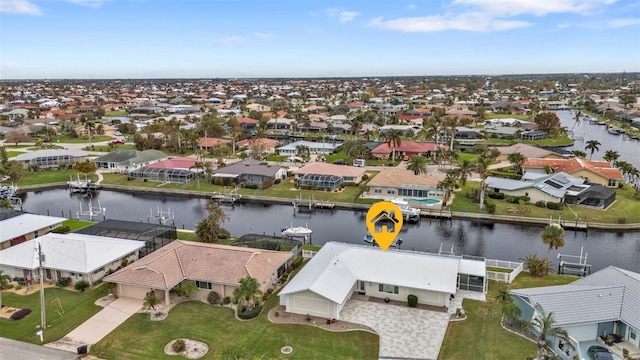 drone / aerial view featuring a residential view and a water view