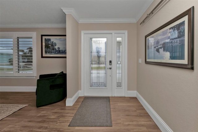 foyer entrance featuring wood-type flooring and crown molding