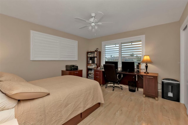 bedroom with light hardwood / wood-style floors and ceiling fan