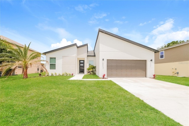 view of front of home with a front lawn and a garage