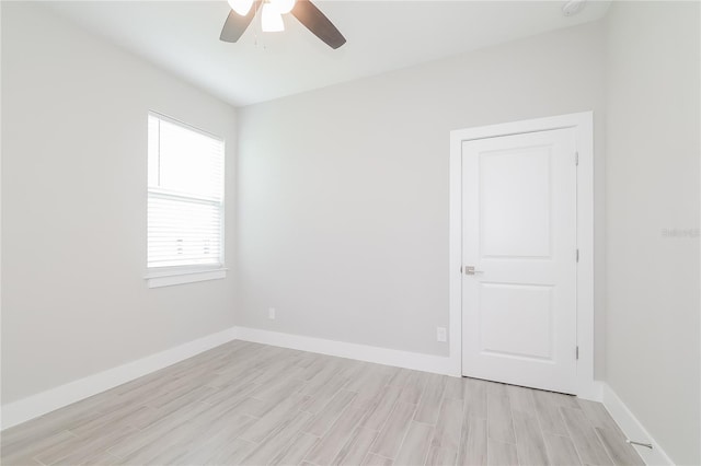 unfurnished room featuring light hardwood / wood-style flooring and ceiling fan