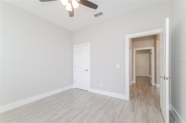 unfurnished bedroom with ceiling fan and light wood-type flooring