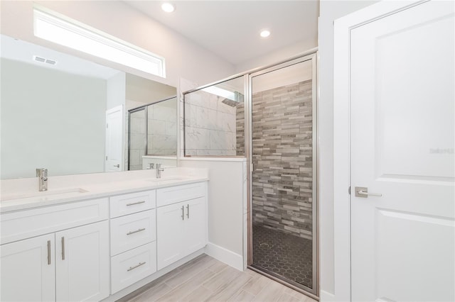 bathroom with vanity and a shower with shower door