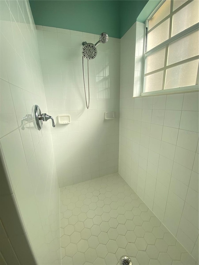 bathroom with a tile shower