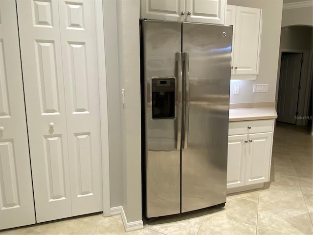 kitchen featuring white cabinetry, stainless steel fridge, and light tile patterned flooring